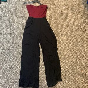 Burgundy and black strapless jumpsuit with zip up back. SIZE M.